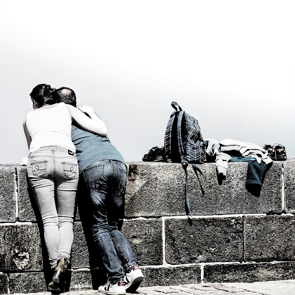 Couple qui regarde derrière un mur