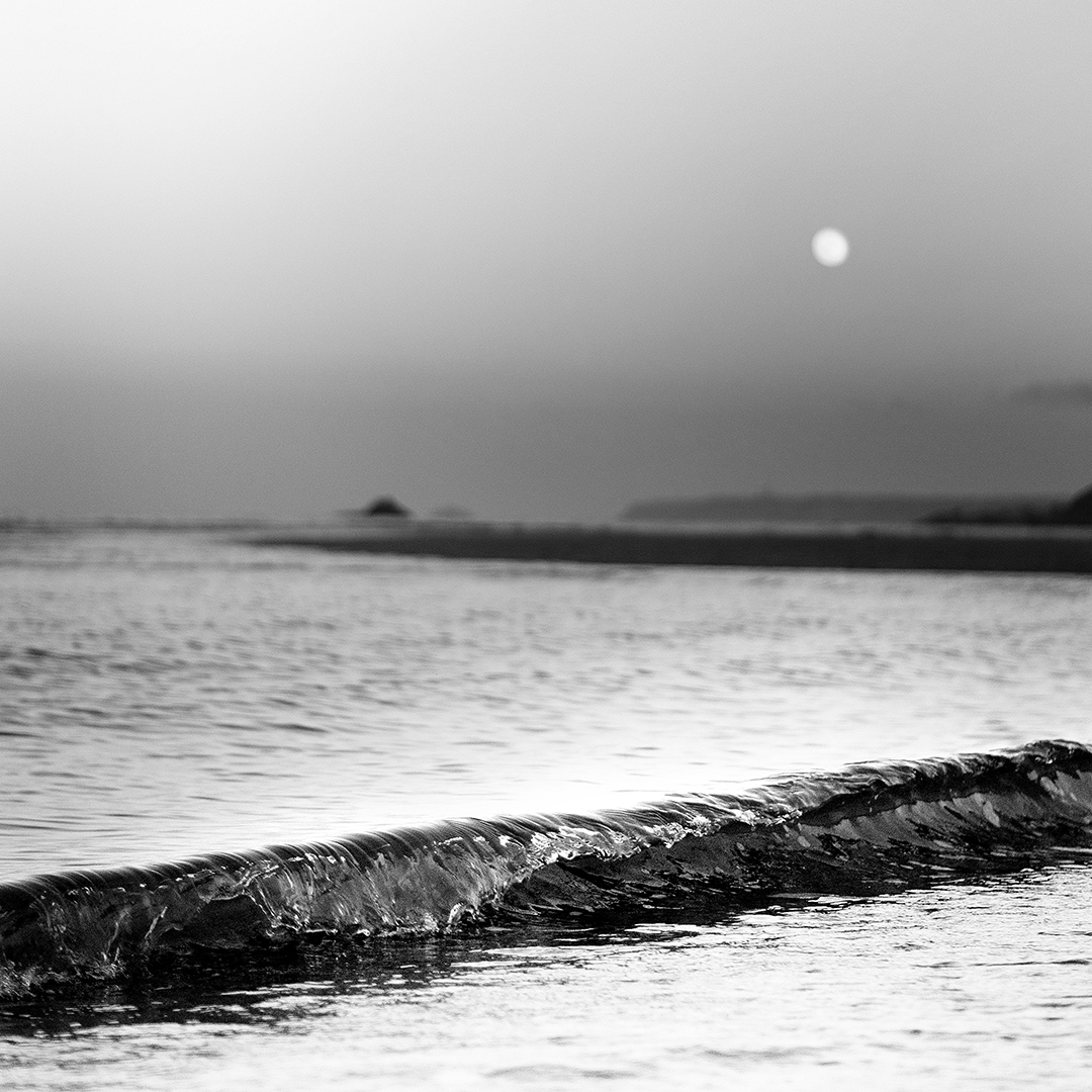 Vague sur plage sous un lever de lune